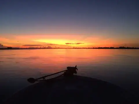 First light over the delta seen past the trolling motor on the bow