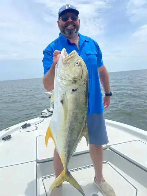 Angler holding up a jack crevalle on the bow near Venice, Louisiana