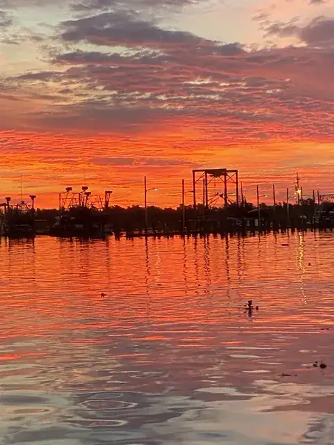 A red sky reflected in the water at the marina in Venice, Louisiana