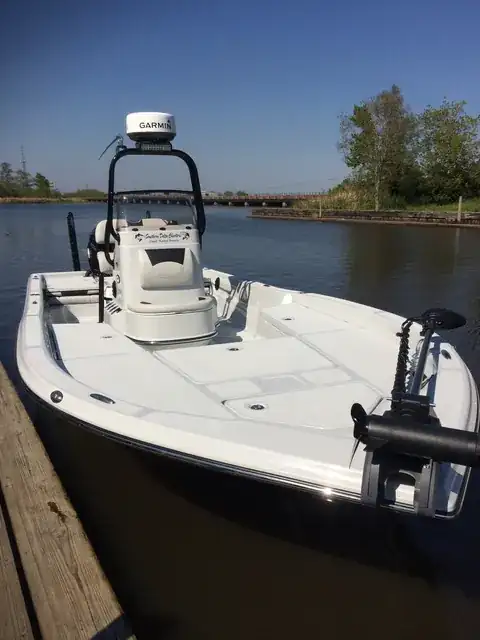 The Southern Delta Charters bay boat tied up at the dock, its console lettered with the charter's name