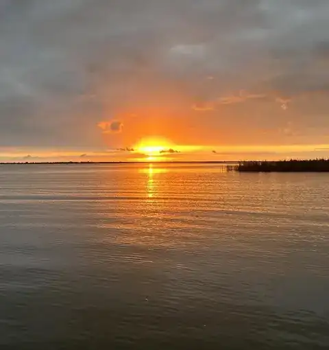 Sun on the horizon over the water in the Venice, Louisiana delta