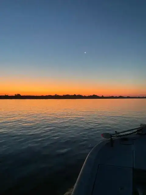 First light over the delta seen from the bow of the boat